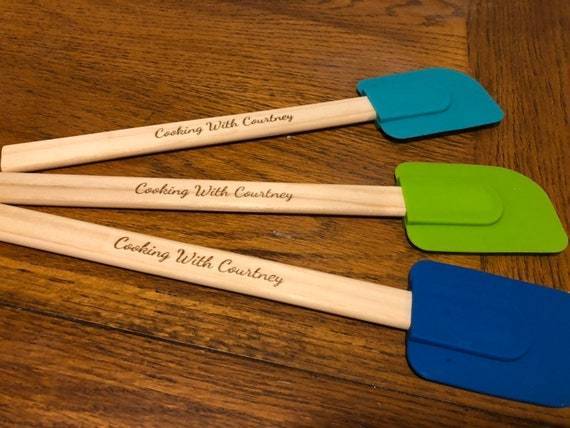 "Laser engraved spatula handle with custom message."